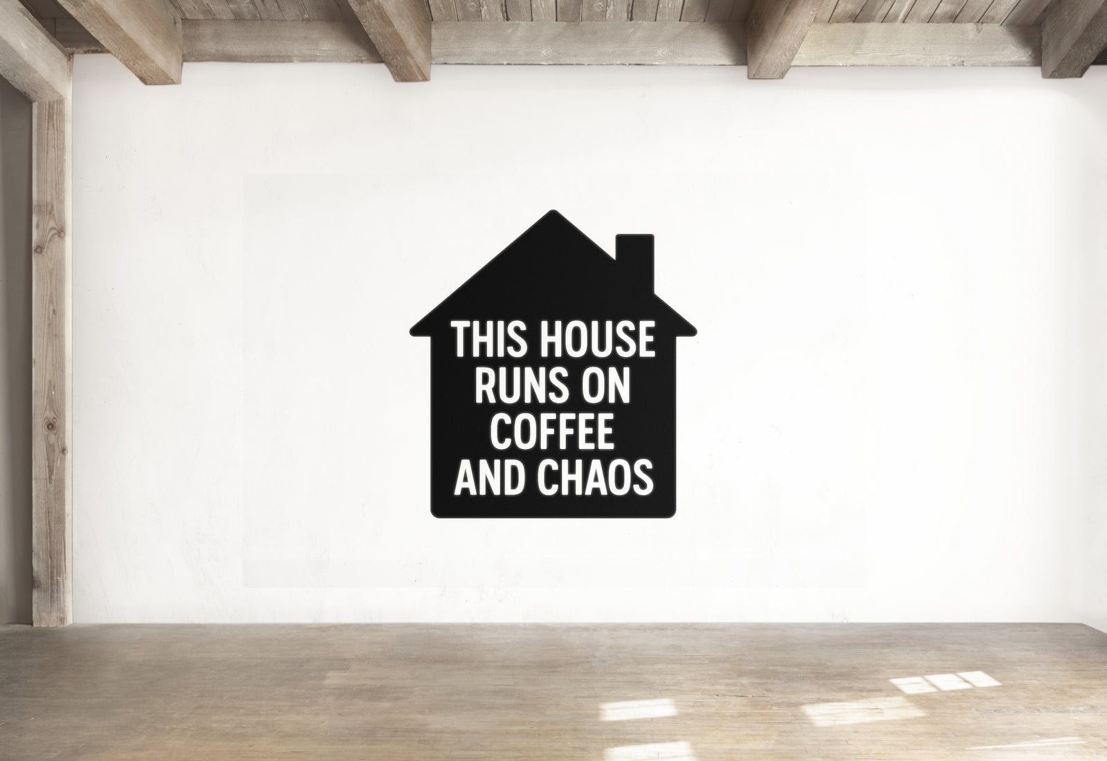 a black and white graphic of a house with the text "THIS HOUSE RUNS ON COFFEE AND CHAOS" written on it.