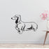 a black and white dog wall decal next to a vase of flowers