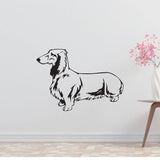 a black and white dog wall decal next to a vase of flowers