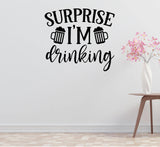 a wall with a humorous text that says "Surprise I'm drinking" in a stylized font.