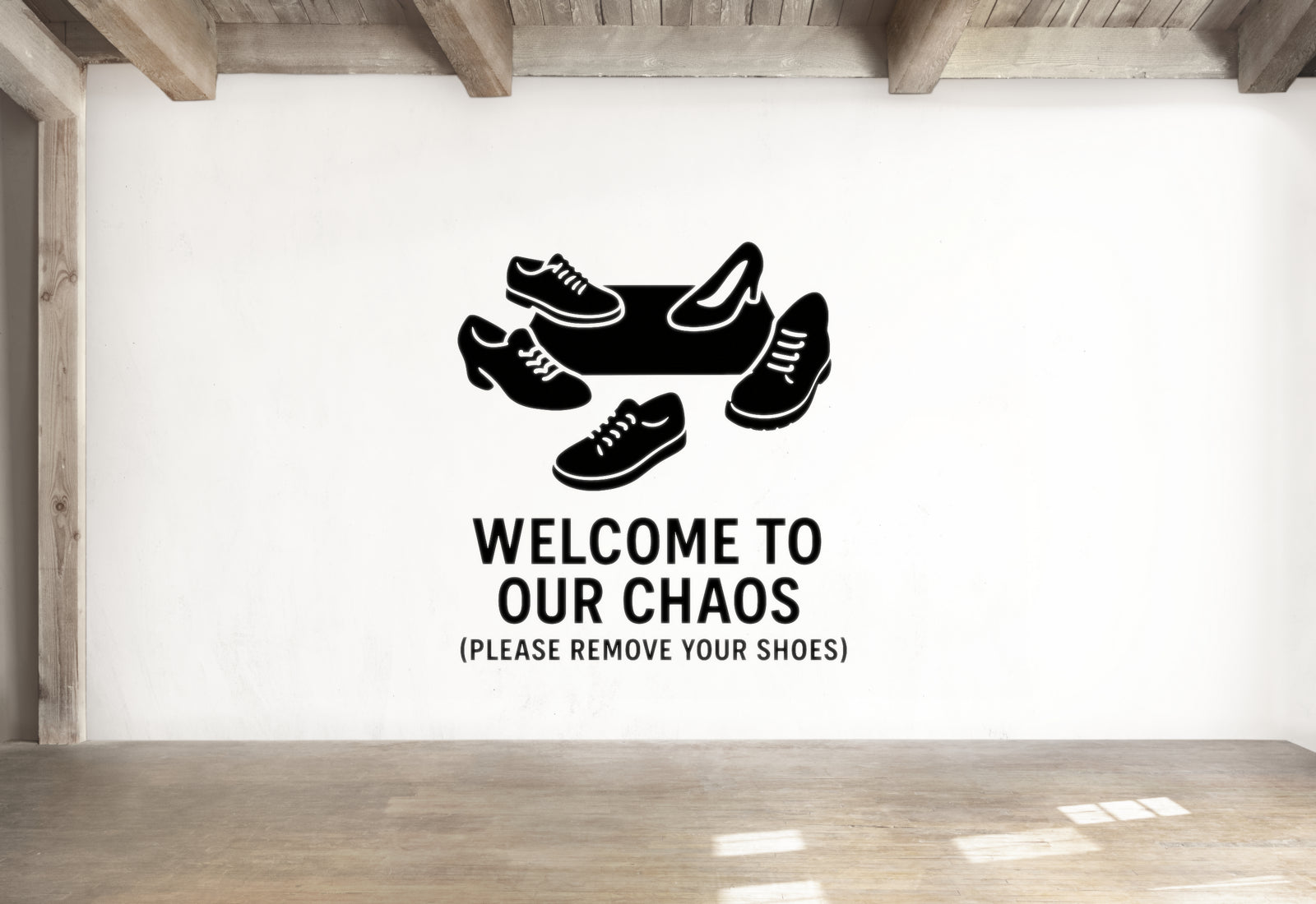 a wall with a sign that says "Welcome to our chaos [PLEASE REMOVE YOUR SHOES]" along with a graphic of shoes.