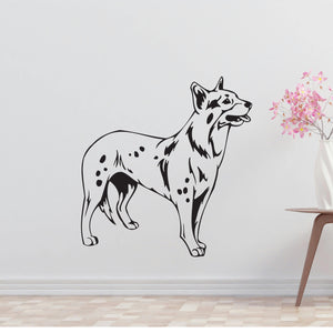 a black and white dog wall decal next to a vase of flowers