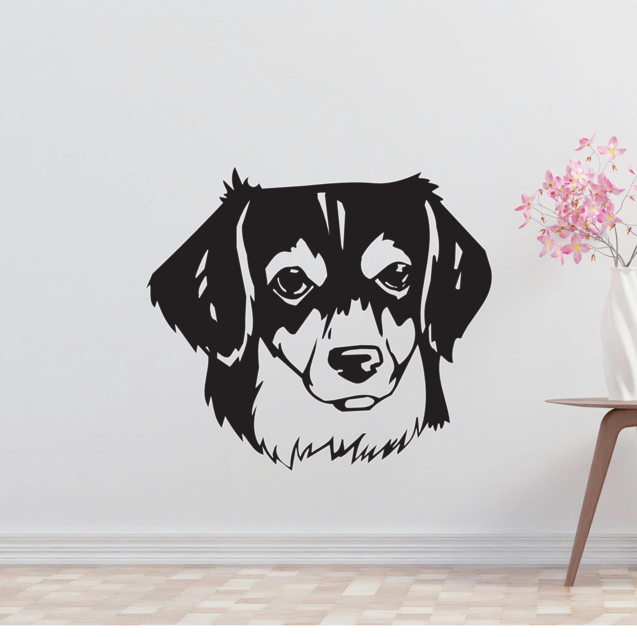 a black and white dog's face on a wall
