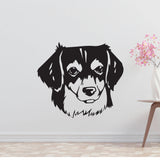 a black and white dog's face on a wall