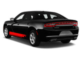a black and red dodge charger parked in front of a white background