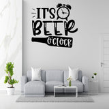 a wall decal with the text "IT'S BEER O'CLOCK" above a couch and a coffee table in a living room setting.