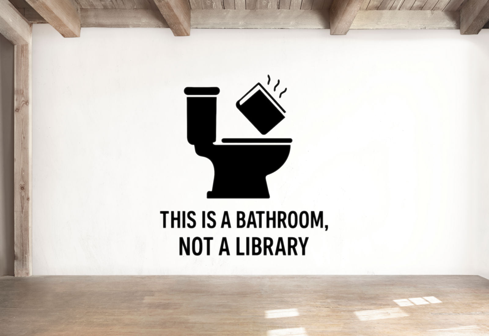 a wall with a black and white graphic of a toilet with a book thrown into it, accompanied by the text "THIS IS A BATHROOM, NOT A LIBRARY".