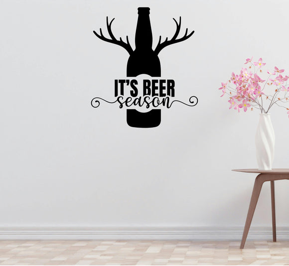 A wall decal with a silhouette of a bottle of beer with antlers and the text 