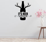 A wall decal with a silhouette of a bottle of beer with antlers and the text "IT'S BEER SEASON" above it.