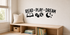 READ PLAY DREAM black vinyl kids wall decal with book, blocks, ball, moon, and stars above a pale oak reading bench.
