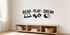 Black Read Play Dream kids wall decal with book, blocks, ball, moon, and stars above a low wooden bookcase.