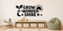 Exact GROW WONDER SHINE black vinyl kids wall decal with sprout, sun, moon, and stars above a pale oak toy cabinet.