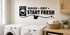 WASH DRY START FRESH black vinyl laundry wall decal with washer, shirt, and sparkles above white laundry machines.