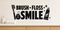 Black Brush Floss Smile bathroom wall decal with toothbrush, floss, toothpaste, and sparkles above a light oak vanity.