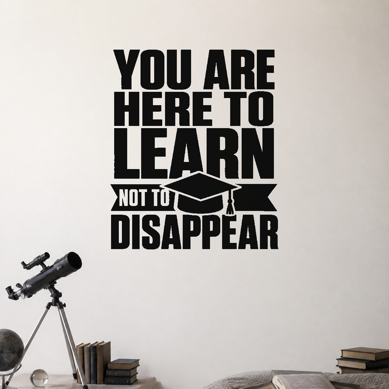 You Are Here to Learn Not to Disappear removable vinyl wall decal shown in a styled room.