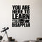 You Are Here to Learn Not to Disappear removable vinyl wall decal shown in a styled room.