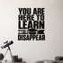 You Are Here to Learn Not to Disappear removable vinyl wall decal shown in a styled room.