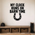 My Clock Runs on Barn Time removable vinyl wall decal shown in a styled room.