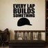 Every Lap Builds Something removable vinyl wall decal shown in a styled room.
