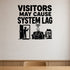 Visitors May Cause System Lag removable vinyl wall decal shown in a styled room.
