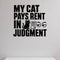 My Cat Pays Rent in Judgment removable vinyl wall decal shown in a styled room.