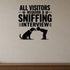 All Visitors Require a Sniffing Interview removable vinyl wall decal shown in a styled room.