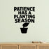 Patience Has a Planting Season removable vinyl wall decal shown in a garden or greenhouse setting.