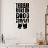 This Bar Runs on Good Company removable vinyl wall decal shown in a styled room.