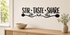 STIR TASTE SHARE black vinyl kitchen wall decal with spoon and herb flourishes above a pale oak console.