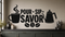 Exact black POUR SIP SAVOR coffee wall decal with steaming mug, pour-over kettle, and coffee beans on a greige coffee-bar wall.