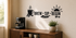 Brew Sip Begin black vinyl coffee bar wall decal above a walnut espresso station in warm morning light.