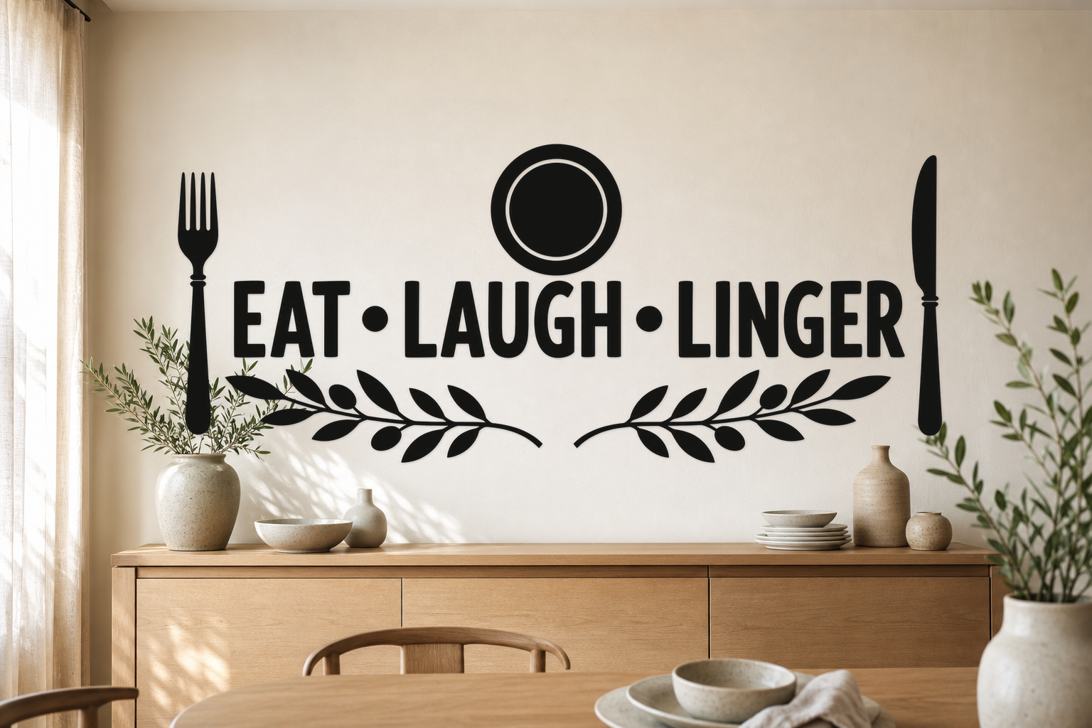 EAT LAUGH LINGER black vinyl dining room wall decal with plate, fork, knife, and olive branches above a pale oak sideboard.