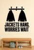 Jackets Hang, Worries Wait removable vinyl wall decal shown in a mudroom / entryway setting.