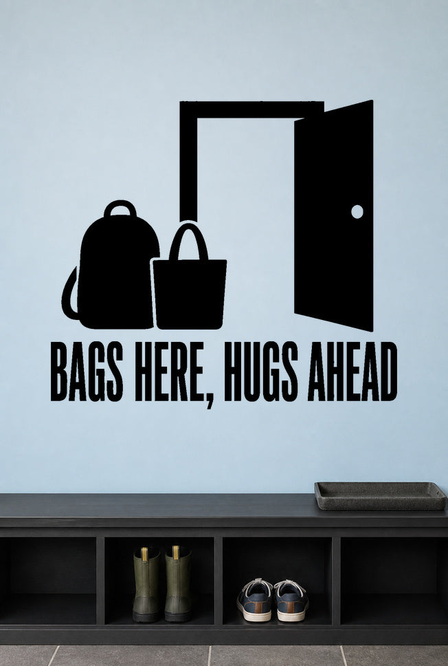 Bags Here, Hugs Ahead removable vinyl wall decal shown in a mudroom / entryway setting.