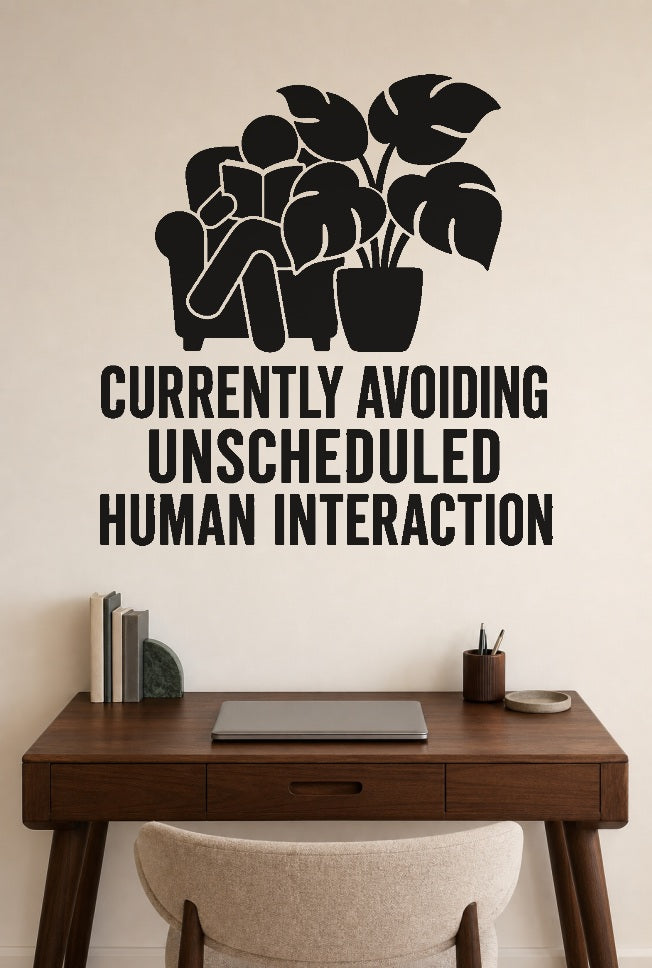 Currently Avoiding Unscheduled Human Interaction black vinyl wall decal shown applied to a smooth interior wall