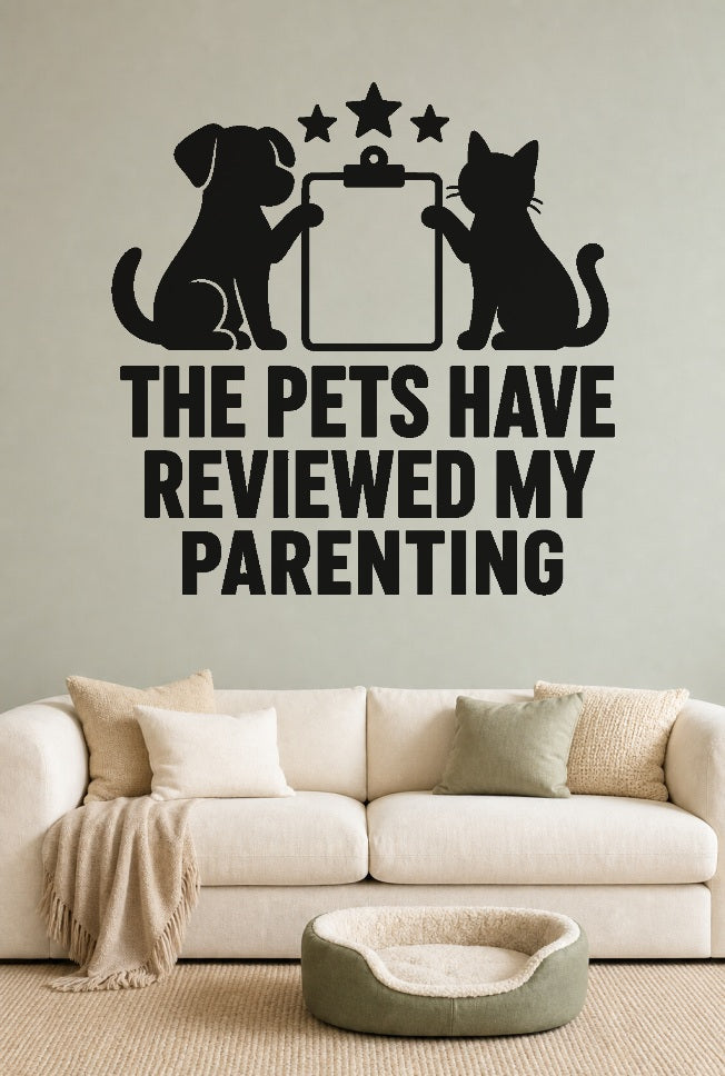 The Pets Have Reviewed My Parenting black vinyl wall decal shown applied to a smooth interior wall