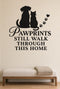 Pawprints Still Walk Through This Home black vinyl wall decal shown applied to a smooth interior wall