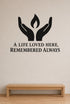 A Life Loved Here, Remembered Always black vinyl wall decal shown applied to a smooth interior wall