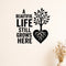 A Beautiful Life Still Grows Here removable vinyl wall decal shown on a smooth interior wall
