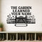 The Garden Learned Your Name large-format removable vinyl wall decal shown on a smooth garden mudroom wall