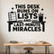 This Desk Runs On Lists And Last-Minute Miracles removable vinyl wall decal shown on a smooth home office wall