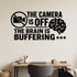 The Camera Is Off The Brain Is Buffering removable vinyl wall decal shown on a smooth home office wall