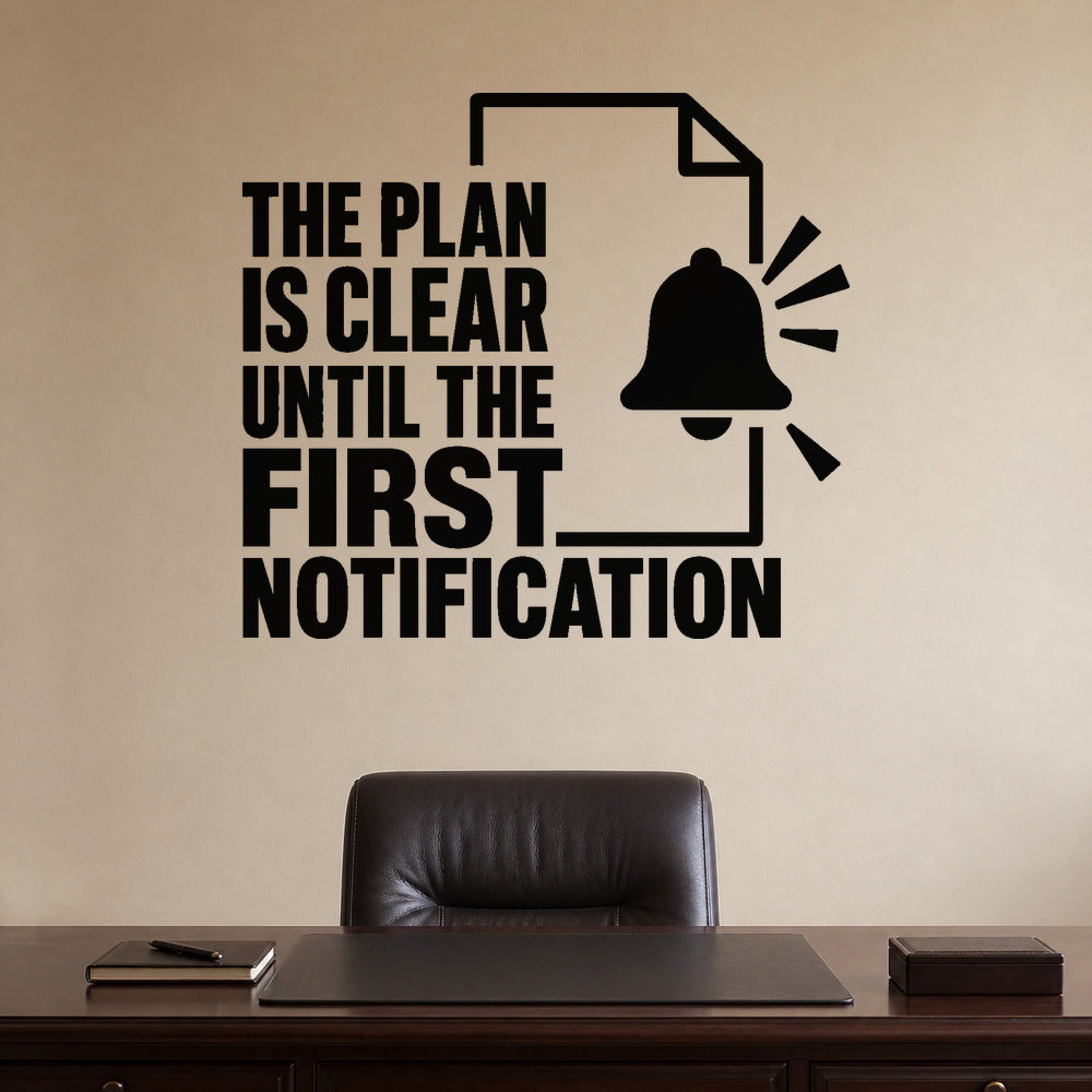 The Plan Is Clear Until The First Notification removable vinyl wall decal shown on a smooth home office wall