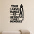 Your Leash Hangs Beside Our Memories removable vinyl wall decal shown on a smooth interior wall