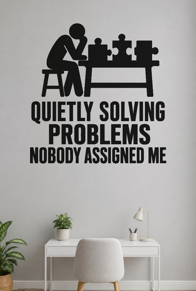 Quietly Solving Problems Nobody Assigned Me black vinyl wall decal shown applied to a smooth interior wall
