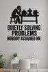 Quietly Solving Problems Nobody Assigned Me black vinyl wall decal shown applied to a smooth interior wall