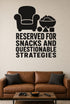 Reserved for Snacks and Questionable Strategies black vinyl wall decal shown applied to a smooth interior wall