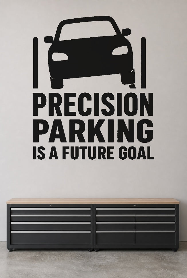 Precision Parking Is a Future Goal black vinyl wall decal shown applied to a smooth interior wall
