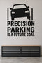 Precision Parking Is a Future Goal black vinyl wall decal shown applied to a smooth interior wall