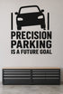 Precision Parking Is a Future Goal black vinyl wall decal shown applied to a smooth interior wall
